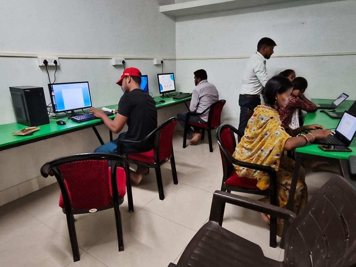 Young people working at computers inside a WOW Hub