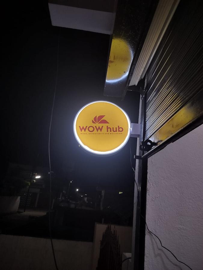 The WOW Hub sign lit at night